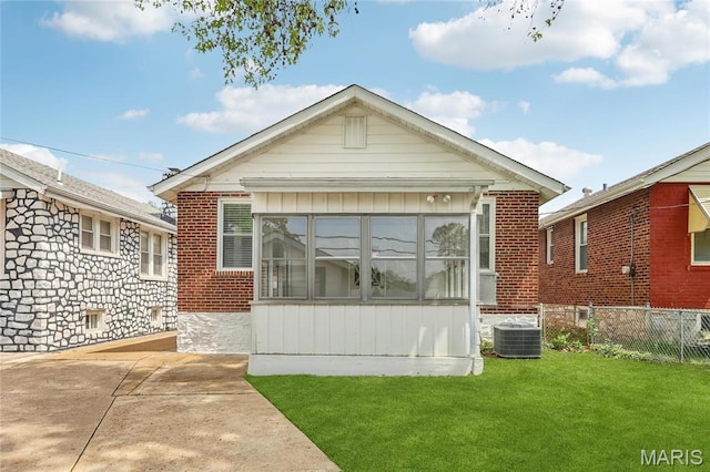 5909 Hampton Ave, Saint Louis, MO 63109 - view of front of home with brick siding, cooling unit, and a patio area