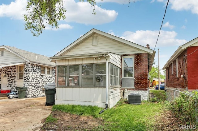 5909 Hampton Ave, Saint Louis, MO 63109 - view of front facade with a sunroom, cooling unit, and fence