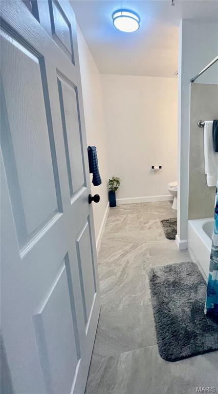 3605 Tracey Rich Rd Unit 1A, Saint Louis, MO 63125 - full bathroom with toilet, shower / bathtub combination, and baseboards