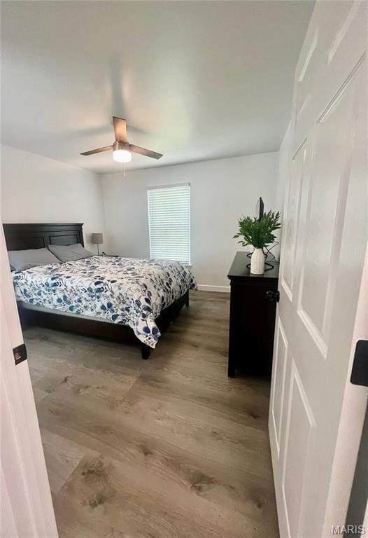 3605 Tracey Rich Rd Unit 1A, Saint Louis, MO 63125 - bedroom featuring wood finished floors, a ceiling fan, and baseboards