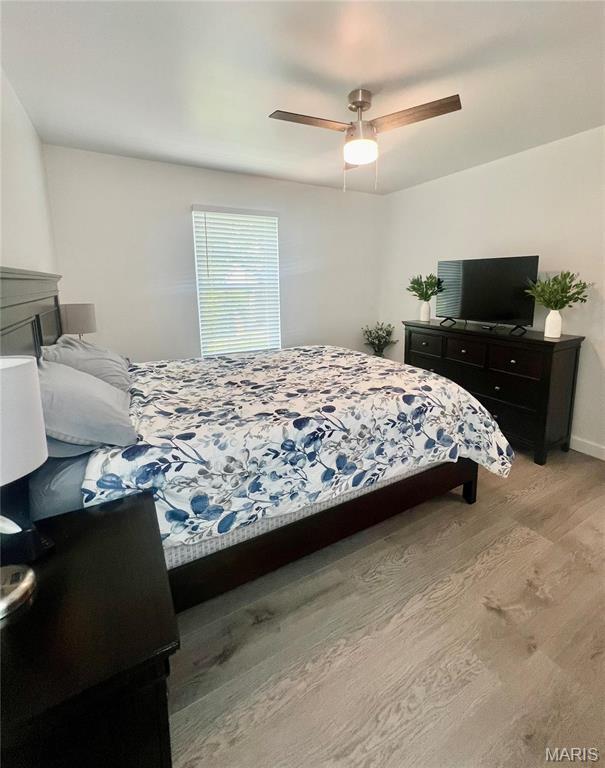3605 Tracey Rich Rd Unit 1A, Saint Louis, MO 63125 - bedroom featuring light wood-type flooring, ceiling fan, and baseboards