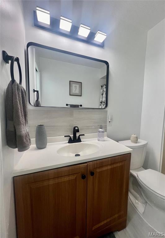 3605 Tracey Rich Rd Unit 1A, Saint Louis, MO 63125 - bathroom with backsplash, vanity, and toilet
