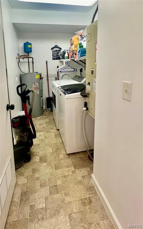 3605 Tracey Rich Rd Unit 1A, Saint Louis, MO 63125 - washroom featuring water heater, washer and dryer, and baseboards