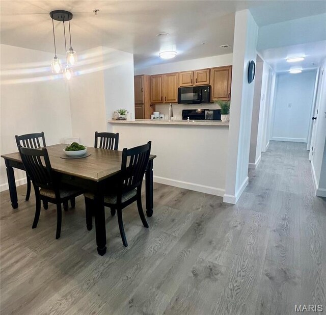 3605 Tracey Rich Rd Unit 1A, Saint Louis, MO 63125 - dining area with wood finished floors and baseboards
