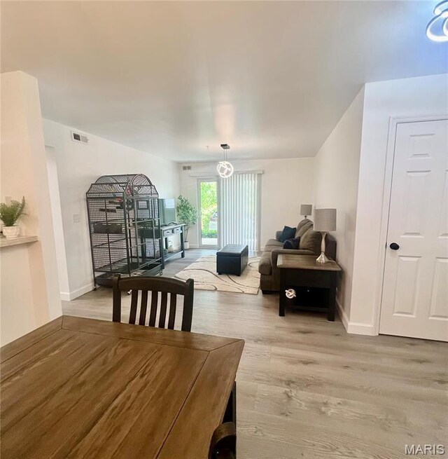 3605 Tracey Rich Rd Unit 1A, Saint Louis, MO 63125 - dining room featuring light wood-type flooring and baseboards