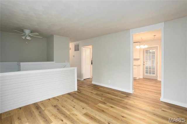 5604 Mark Trl, House Springs, MO 63051 - empty room featuring baseboards, light wood-style flooring, a ceiling fan, and a chandelier