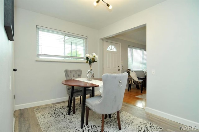 7051 Lansdowne Ave, Saint Louis, MO 63109 - dining room with healthy amount of natural light, light wood-type flooring, and baseboards