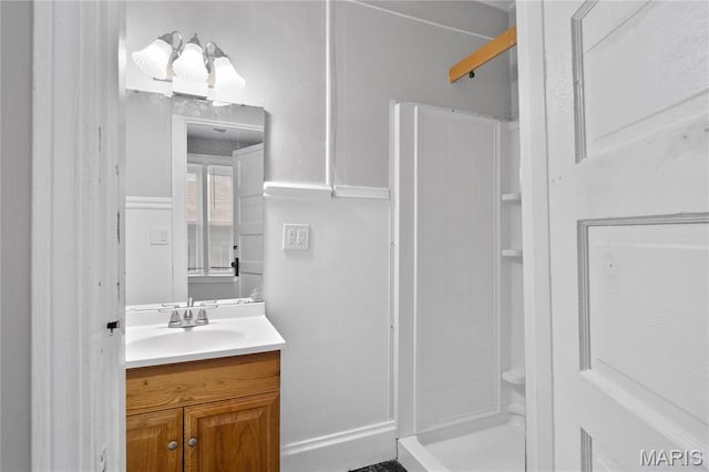 bathroom with a stall shower and vanity