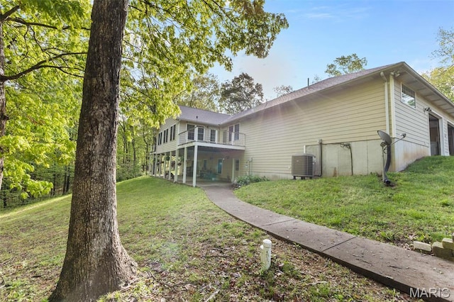102 Timber Ln, Farmington, MO 63640 - back of property with cooling unit, a lawn, and a balcony
