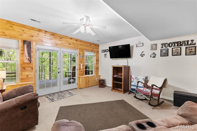102 Timber Ln, Farmington, MO 63640 - carpeted living room featuring wood walls, plenty of natural light, french doors, a ceiling fan, and baseboards