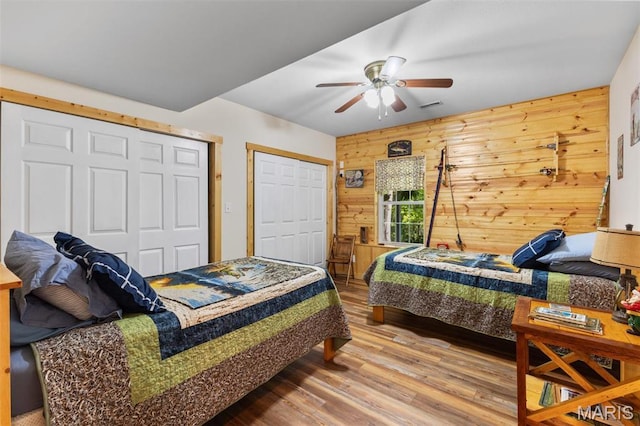 102 Timber Ln, Farmington, MO 63640 - bedroom featuring wooden walls, wood finished floors, and ceiling fan