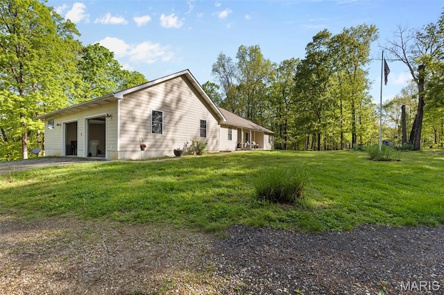 102 Timber Ln, Farmington, MO 63640 - view of side of property with a garage, driveway, and a yard