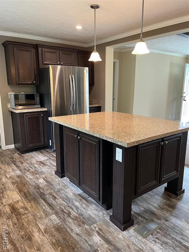 474 Bluffview Dr, Piedmont, MO 63957 - kitchen with stainless steel appliances, wood finished floors, a center island, ornamental molding, and pendant lighting