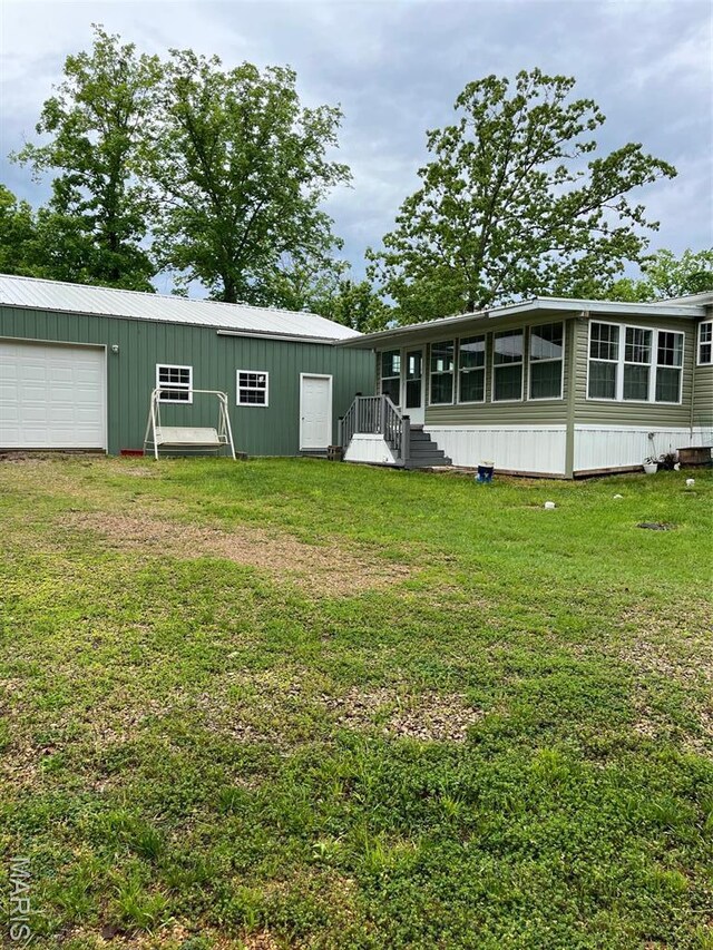 474 Bluffview Dr, Piedmont, MO 63957 - back of property with a yard and board and batten siding