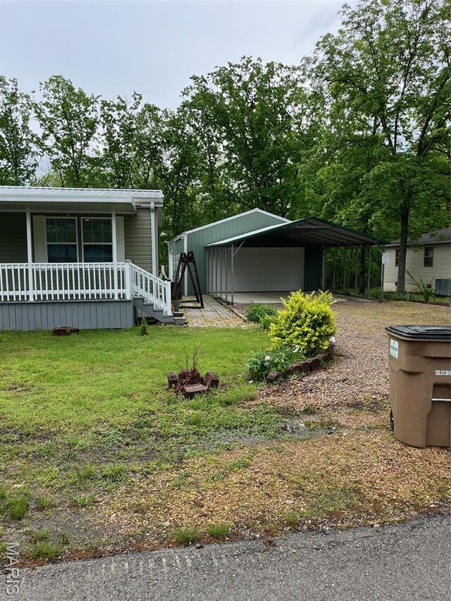 474 Bluffview Dr, Piedmont, MO 63957 - view of green lawn featuring covered porch and a carport