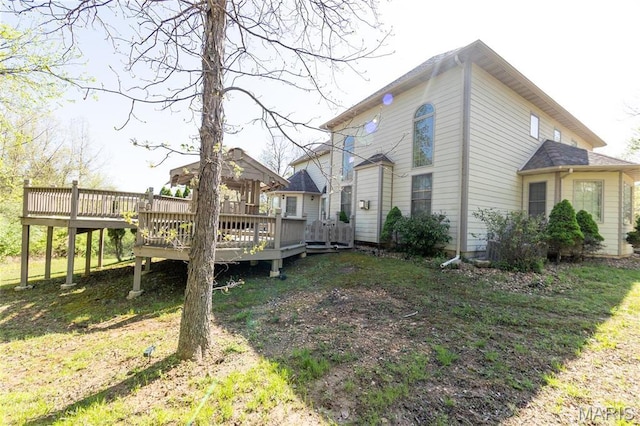 view of side of home with a wooden deck