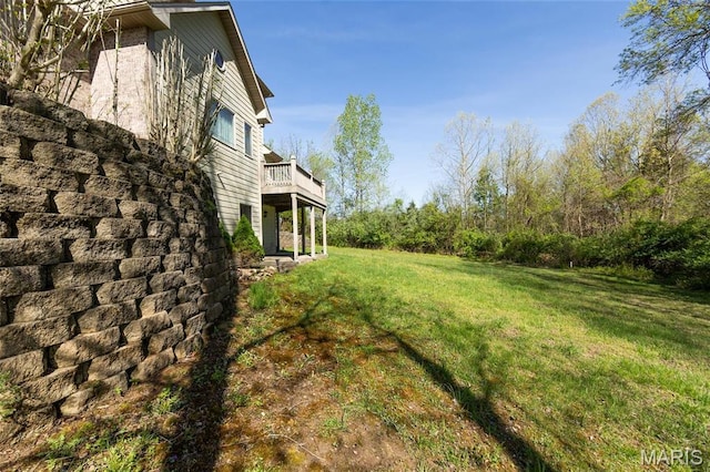 view of green lawn with a deck