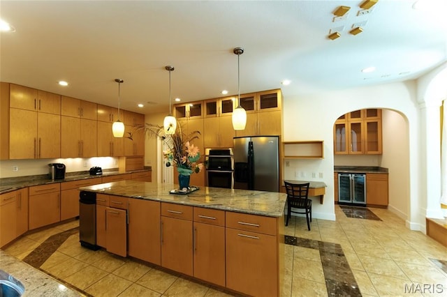 1025 Cobblestone Dr, Rolla, MO 65401 - kitchen featuring refrigerator with ice dispenser, double oven, a center island, inlaid floor details, and recessed lighting