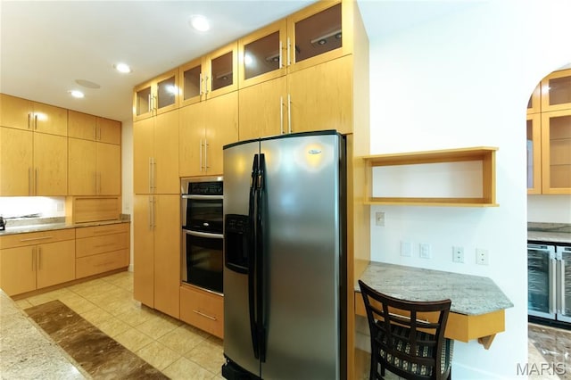 1025 Cobblestone Dr, Rolla, MO 65401 - kitchen with fridge with ice dispenser, stainless steel double oven, wine cooler, recessed lighting, and glass insert cabinets