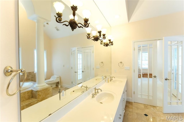 1025 Cobblestone Dr, Rolla, MO 65401 - full bath with ornate columns, double vanity, toilet, tile patterned flooring, and baseboards
