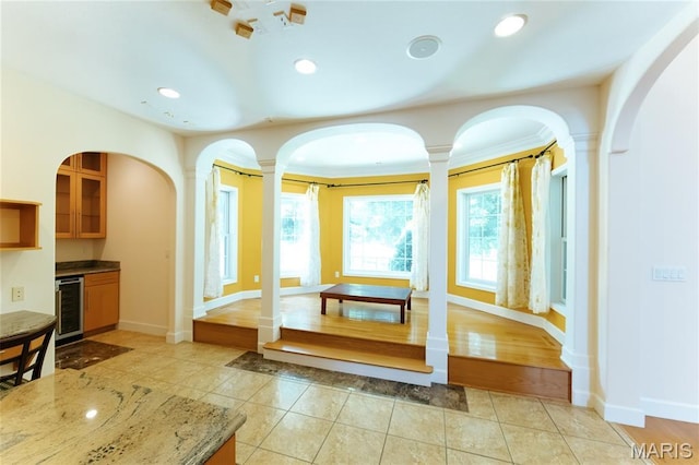 1025 Cobblestone Dr, Rolla, MO 65401 - living room with wine cooler, light tile patterned flooring, decorative columns, recessed lighting, and baseboards