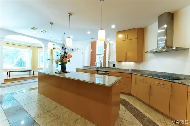 1025 Cobblestone Dr, Rolla, MO 65401 - kitchen featuring wall chimney range hood, black electric stovetop, arched walkways, a kitchen island, and recessed lighting