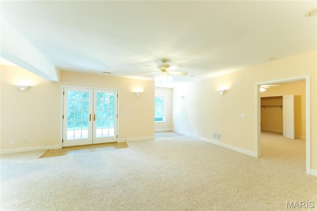 1025 Cobblestone Dr, Rolla, MO 65401 - empty room with ceiling fan, light colored carpet, french doors, and baseboards