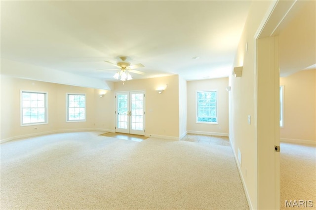 1025 Cobblestone Dr, Rolla, MO 65401 - empty room with light colored carpet, baseboards, a ceiling fan, and french doors