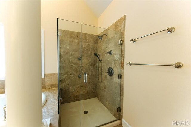 1025 Cobblestone Dr, Rolla, MO 65401 - bathroom with a shower stall and vaulted ceiling