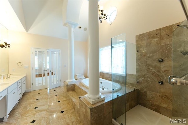 1025 Cobblestone Dr, Rolla, MO 65401 - bathroom featuring ornate columns, double vanity, a garden tub, a tile shower, and a towering ceiling