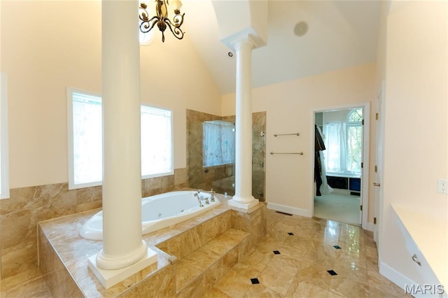 1025 Cobblestone Dr, Rolla, MO 65401 - bathroom featuring ornate columns, a tub with jets, tiled shower, and lofted ceiling