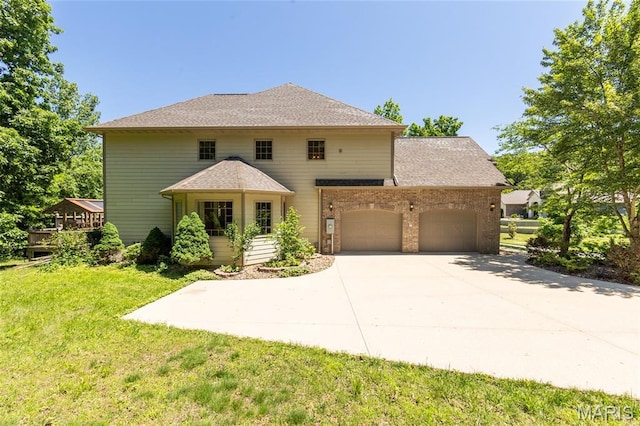 1025 Cobblestone Dr, Rolla, MO 65401 - traditional-style house with a garage, a front yard, concrete driveway, and brick siding
