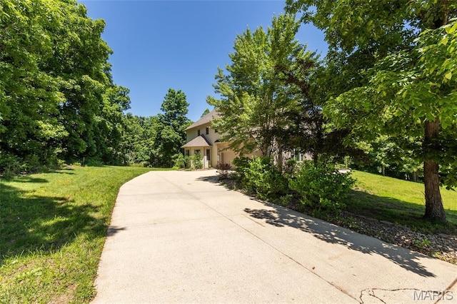 1025 Cobblestone Dr, Rolla, MO 65401 - obstructed view of property with concrete driveway, a front yard, and a garage
