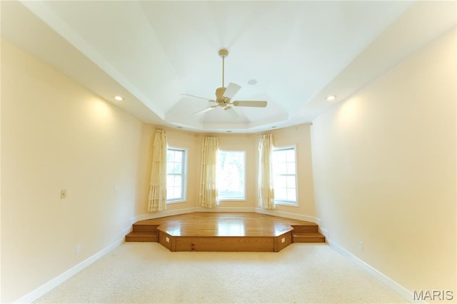 1025 Cobblestone Dr, Rolla, MO 65401 - carpeted spare room featuring a tray ceiling, a ceiling fan, baseboards, and recessed lighting