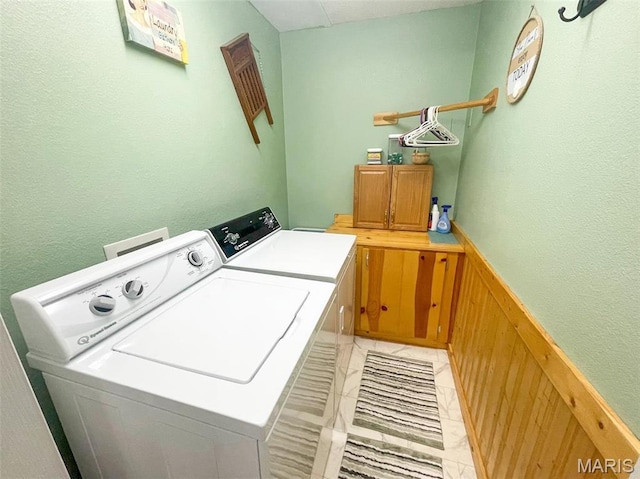 11652 Two Mile Rd, Dexter, MO 63841 - laundry room featuring separate washer and dryer, cabinet space, a wainscoted wall, and wood walls