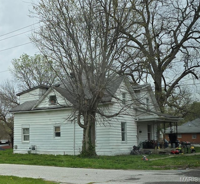 109 S 6th St, Elsberry, MO 63343 - view of property exterior with a yard, a porch, and a shingled roof