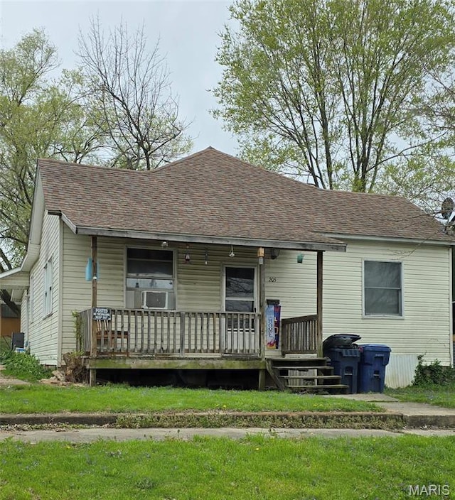 109 S 6th St, Elsberry, MO 63343 - view of front of house featuring a porch, roof with shingles, and cooling unit