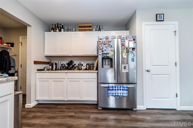 kitchen featuring stainless steel refrigerator with ice dispenser, dark wood-type flooring, white cabinetry, and light countertops