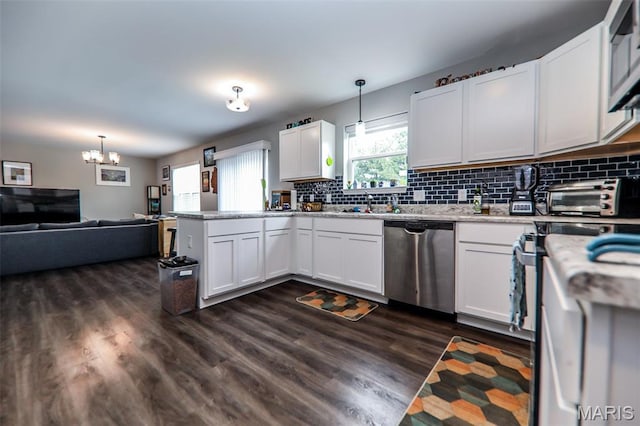 kitchen with stainless steel dishwasher, a peninsula, backsplash, white cabinetry, and dark wood finished floors