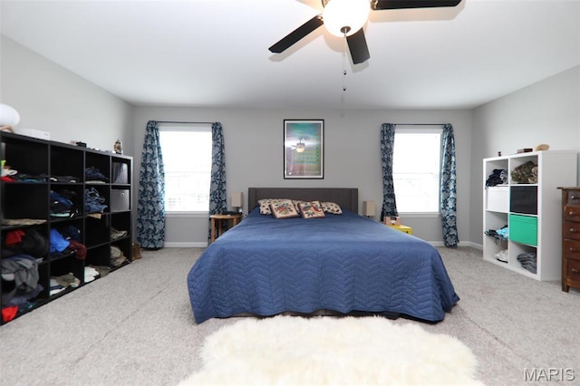 carpeted bedroom with baseboards and ceiling fan