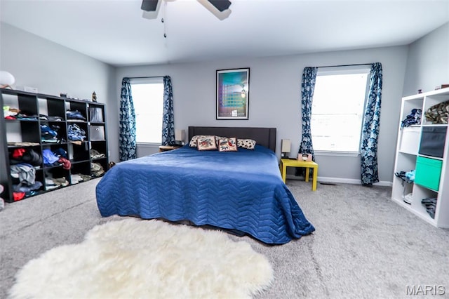 bedroom with carpet flooring, baseboards, and a ceiling fan