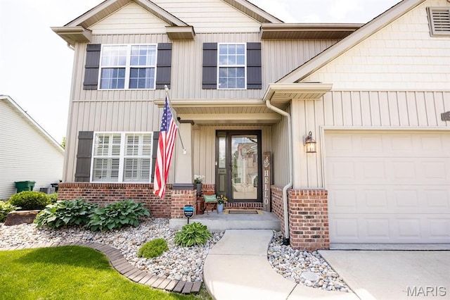 doorway to property featuring brick siding and an attached garage