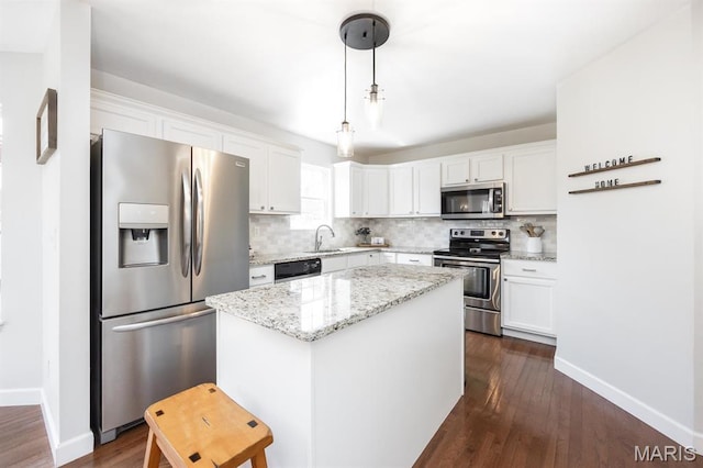 kitchen featuring appliances with stainless steel finishes, white cabinetry, and tasteful backsplash