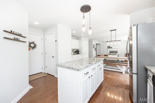 kitchen with freestanding refrigerator, dark wood-style flooring, a center island, white cabinetry, and recessed lighting