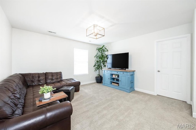 living area with baseboards, light colored carpet, and a chandelier