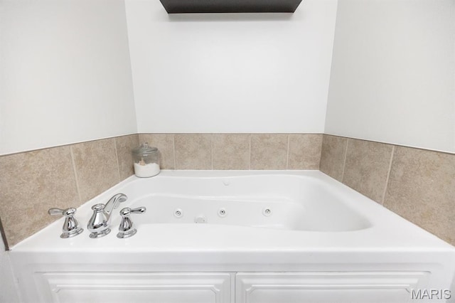 full bathroom featuring a tub with jets