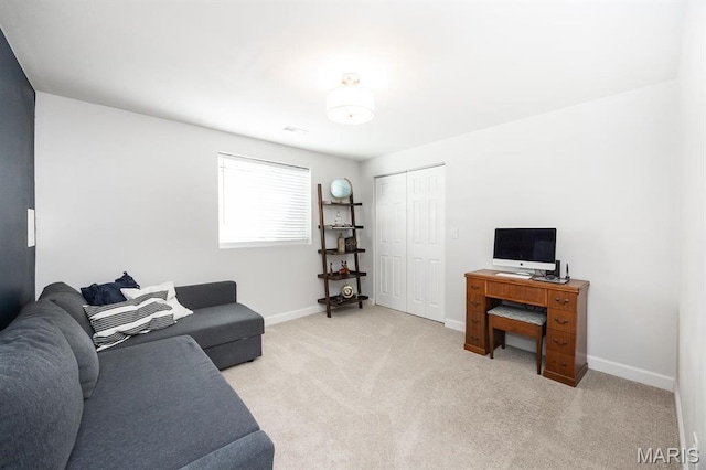 living room featuring baseboards and light carpet