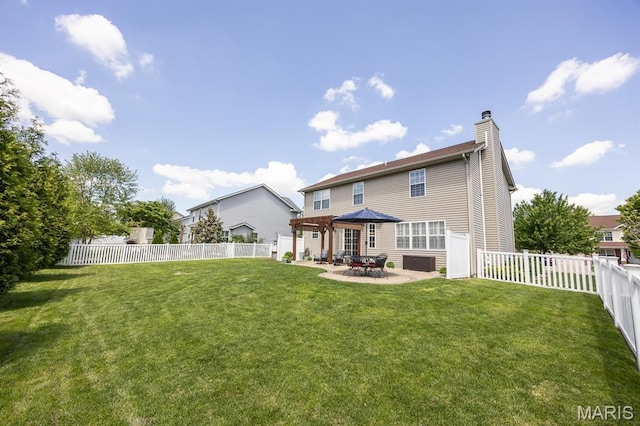back of property with a chimney and a patio area