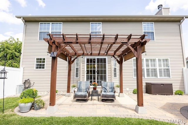 back of property with a pergola, a chimney, a patio, and central air condition unit