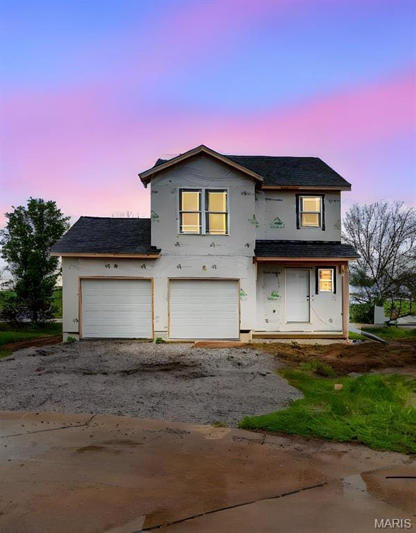 1404 Orchard Lakes Cir, Belleville, IL 62220 - unfinished property featuring driveway, stucco siding, roof with shingles, and a garage